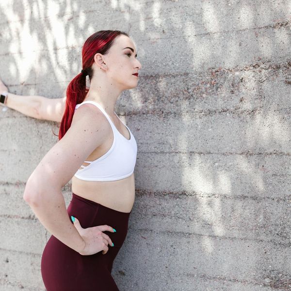 Person feeling energized and stretching outdoors at sunrise.